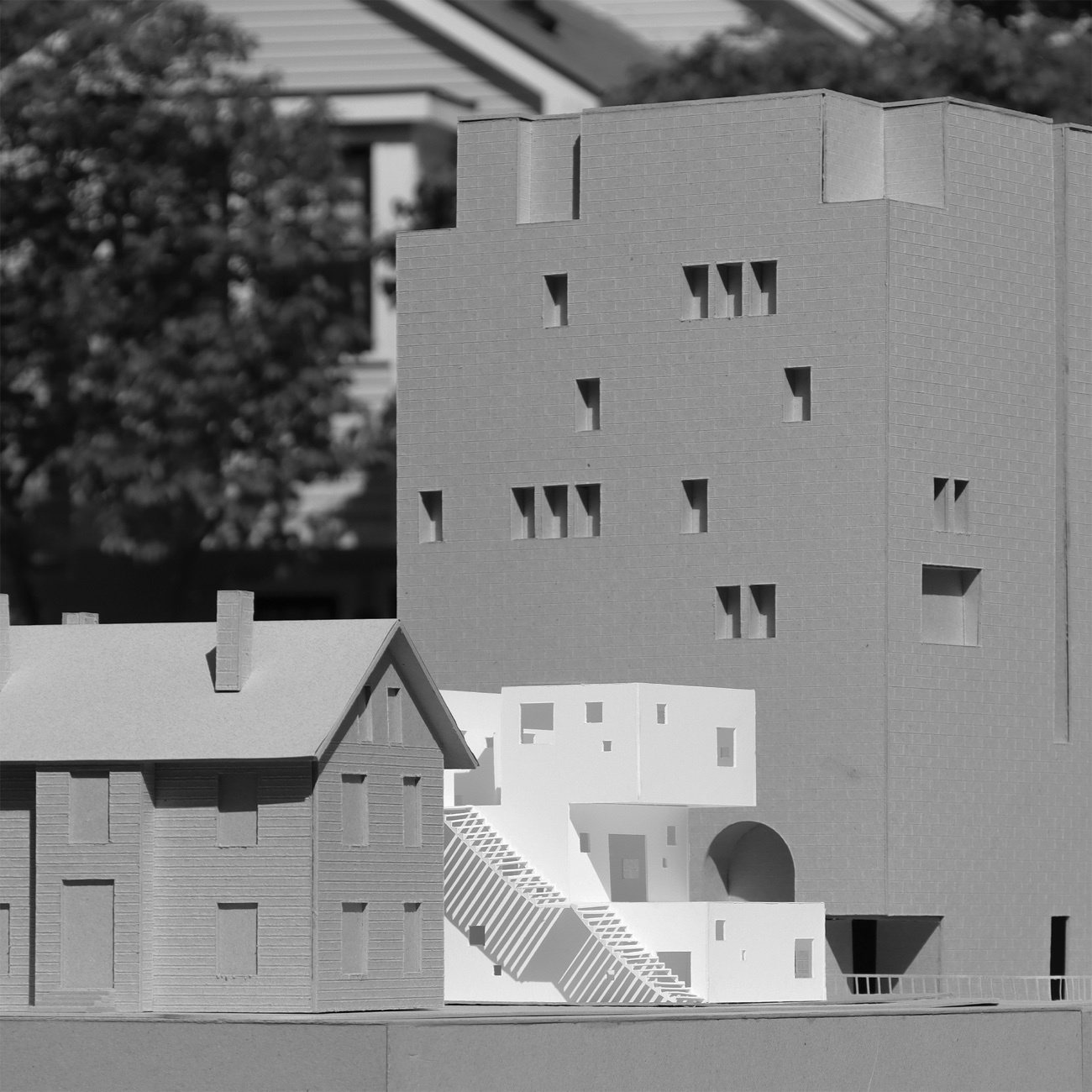 Learning Across Levels, context model beside an existing house